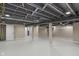 Finished basement with open concept, gray painted ceiling joists and white floors at 7999 Englewood Rd, Indianapolis, IN 46240