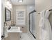 Well-lit bathroom features a stylish vanity, framed mirror, and shower with sleek black trim at 7999 Englewood Rd, Indianapolis, IN 46240