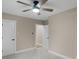 Bedroom with a ceiling fan, carpet, and two doorways that create an open, airy feeling at 7999 Englewood Rd, Indianapolis, IN 46240