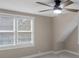 Bedroom with natural light provided by the double windows, modern ceiling fan, and neutral walls at 7999 Englewood Rd, Indianapolis, IN 46240