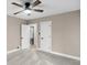 Bright bedroom featuring neutral walls, a fan, carpet, and white trim, offering comfort and style at 7999 Englewood Rd, Indianapolis, IN 46240