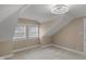 Unique bedroom featuring vaulted ceilings, two windows, neutral walls, and plush carpeting at 7999 Englewood Rd, Indianapolis, IN 46240