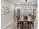 This dining room features a wooden table, modern light fixture, and neutral decor at 7999 Englewood Rd, Indianapolis, IN 46240