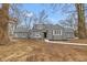 Charming gray home featuring updated windows and professional landscaping at 7999 Englewood Rd, Indianapolis, IN 46240