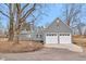 Spacious two-car garage with new doors complementing the gray home at 7999 Englewood Rd, Indianapolis, IN 46240