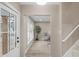 Inviting hallway leading to a cozy sitting area with ample natural light and modern flooring at 7999 Englewood Rd, Indianapolis, IN 46240