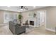 Comfortable living room with a fireplace, neutral colors, and a large window at 7999 Englewood Rd, Indianapolis, IN 46240