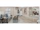 Bright living room with a gray sofa, decor, and modern decor with access to dining area at 7999 Englewood Rd, Indianapolis, IN 46240