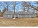 Rear of home featuring neutral siding and an accessible rear entry at 7999 Englewood Rd, Indianapolis, IN 46240