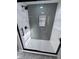 Modern shower featuring contrasting tile, matte black fixtures, and glass shower door at 7999 Englewood Rd, Indianapolis, IN 46240