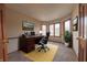 Inviting office featuring hardwood trim, large windows, and a bright yellow rug at 8150 Foxchase Cir, Indianapolis, IN 46256