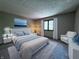 Comfortable main bedroom with soft carpet, bright window, and contemporary furniture at 8150 Foxchase Cir, Indianapolis, IN 46256