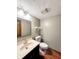 Bathroom featuring single sink vanity, decorative lighting, and hard wood floors at 8150 Foxchase Cir, Indianapolis, IN 46256