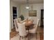 Charming dining area featuring a wood table, upholstered chairs, and stylish light fixture at 8501 Canterbury E Sq, Indianapolis, IN 46260