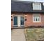 Charming brick townhouse with well-maintained landscaping and a dark roof at 8501 Canterbury E Sq, Indianapolis, IN 46260