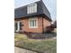 Brick townhouse exterior featuring dormer window and landscaped yard at 8501 Canterbury E Sq, Indianapolis, IN 46260