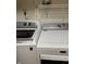 Laundry area with modern, matching, GE and Maytag washer and dryer units at 8501 Canterbury E Sq, Indianapolis, IN 46260