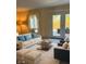 Bright living room with neutral tones, plush seating, and glass doors to outdoor patio at 8501 Canterbury E Sq, Indianapolis, IN 46260