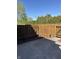 Enclosed backyard featuring a wood fence, stone, and landscaping providing an outdoor retreat at 8501 Canterbury E Sq, Indianapolis, IN 46260