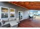 Cozy back porch has wood ceiling, sliding glass door, wicker furniture and outdoor dining set at 9063 Moyer Pl, Pendleton, IN 46064