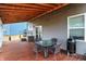 Relaxing back porch offers a wood ceiling, BBQ and dining set, perfect for outdoor entertaining at 9063 Moyer Pl, Pendleton, IN 46064