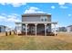 Open backyard with a covered wood porch and outdoor seating, perfect for relaxing or entertaining at 9063 Moyer Pl, Pendleton, IN 46064