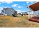 Large, green backyard features a playset, a lawn and covered wood back porch at 9063 Moyer Pl, Pendleton, IN 46064