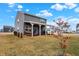Beautiful backyard features a wood covered porch with outdoor seating, set on lush grass at 9063 Moyer Pl, Pendleton, IN 46064