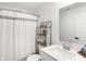Bright bathroom featuring a shower-tub combo with modern fixtures, vanity, and shelving unit at 9063 Moyer Pl, Pendleton, IN 46064
