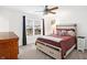 Bright bedroom features a ceiling fan, large window, and comfortable bed with stylish bedding at 9063 Moyer Pl, Pendleton, IN 46064