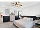 Neutral bedroom features a ceiling fan, tray ceilings, wainscoting, and decor accents at 9063 Moyer Pl, Pendleton, IN 46064