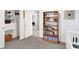 Bright bedroom features a walk-in closet, open door to the hall, and bookshelf stocked with books at 9063 Moyer Pl, Pendleton, IN 46064