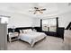 Bright bedroom boasts a tray ceiling, ceiling fan, large windows, and black and white wainscoting at 9063 Moyer Pl, Pendleton, IN 46064