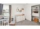 Bedroom with a crib, rocking chair, dresser, and closet with built-in storage at 9063 Moyer Pl, Pendleton, IN 46064