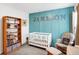 Well-decorated Bedroom with a crib, rocker, and bookshelf at 9063 Moyer Pl, Pendleton, IN 46064