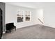 Spacious bonus room features plush carpet, natural light, and cozy seating, perfect for relaxing at 9063 Moyer Pl, Pendleton, IN 46064