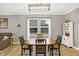 Dining area with a hardwood table, accent lighting, and a large window at 9063 Moyer Pl, Pendleton, IN 46064