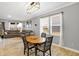 Dining area with hardwood table, large windows, adjacent to the living area at 9063 Moyer Pl, Pendleton, IN 46064