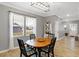 Dining area with a hardwood table, accent lighting, and a large window at 9063 Moyer Pl, Pendleton, IN 46064