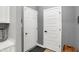 The hallway is freshly painted with all white doors and a woven basket for storage at 9063 Moyer Pl, Pendleton, IN 46064