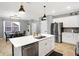 Modern kitchen with stainless steel appliances and a bright white island at 9063 Moyer Pl, Pendleton, IN 46064