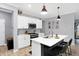 Modern kitchen with white cabinetry, stainless steel appliances, and island with seating for a contemporary design at 9063 Moyer Pl, Pendleton, IN 46064