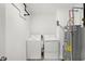 Functional laundry room features a washing machine, dryer, and modern water heater at 9063 Moyer Pl, Pendleton, IN 46064
