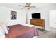 Bright main bedroom with a ceiling fan, TV, and a comfortable-looking bed at 9063 Moyer Pl, Pendleton, IN 46064