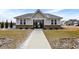 View of the pool house exterior with a landscaped walkway leading up to the entrance at 9063 Moyer Pl, Pendleton, IN 46064