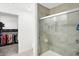 Stylish bathroom with tile shower, glass door and view into walk-in closet at 9063 Moyer Pl, Pendleton, IN 46064