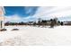 A snowy backyard with single Gathering homes in the background, on a sunny day at 9239 Stones Ferry Way, Indianapolis, IN 46278