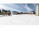 A large, snowy backyard with single Gathering homes in the background at 9239 Stones Ferry Way, Indianapolis, IN 46278