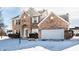 Beautiful brick home with attached garage and snow-covered yard and driveway at 9239 Stones Ferry Way, Indianapolis, IN 46278
