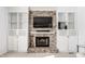 Close-up of a brick fireplace with a mantel, built-in shelving, and classic design elements at 9239 Stones Ferry Way, Indianapolis, IN 46278